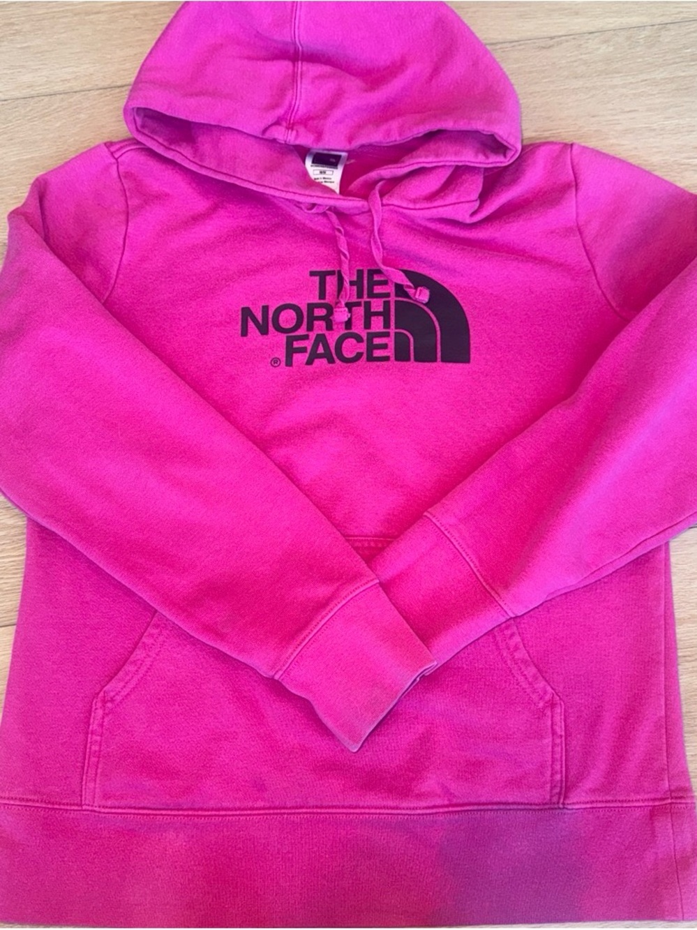 The North Face women’s Bright Pink Hoodie with Black Logo